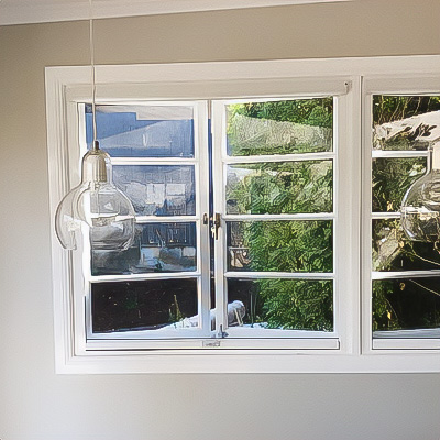 Outward opening windows with retractable insect screen